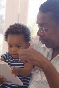 Grandfather shares a book